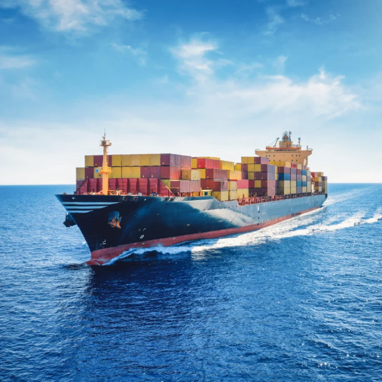 Image of U.S. Importer's Container Ship on the Ocean With Blue Skies and Moderate Cloud Cover